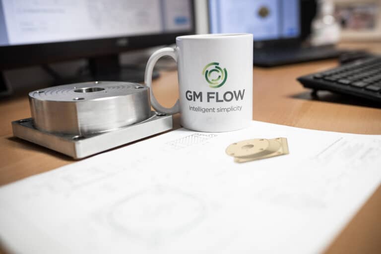 Gas flow meter technical drawing on desk