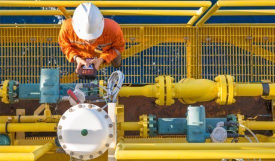Offshore oil technician performing equipment check